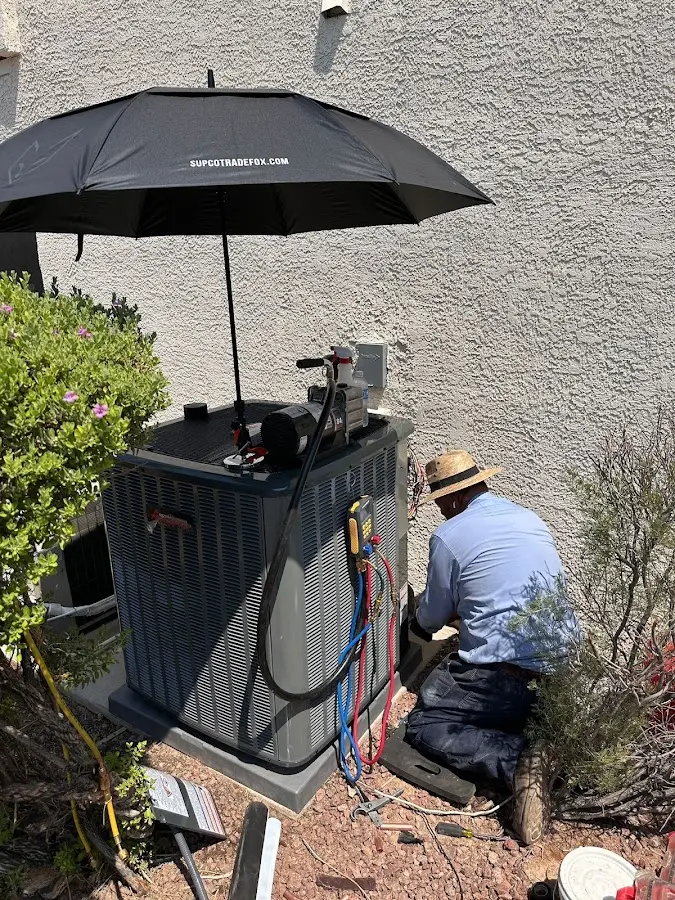 HVAC technician performing outdoor AC maintenance in Wilkes-Barre