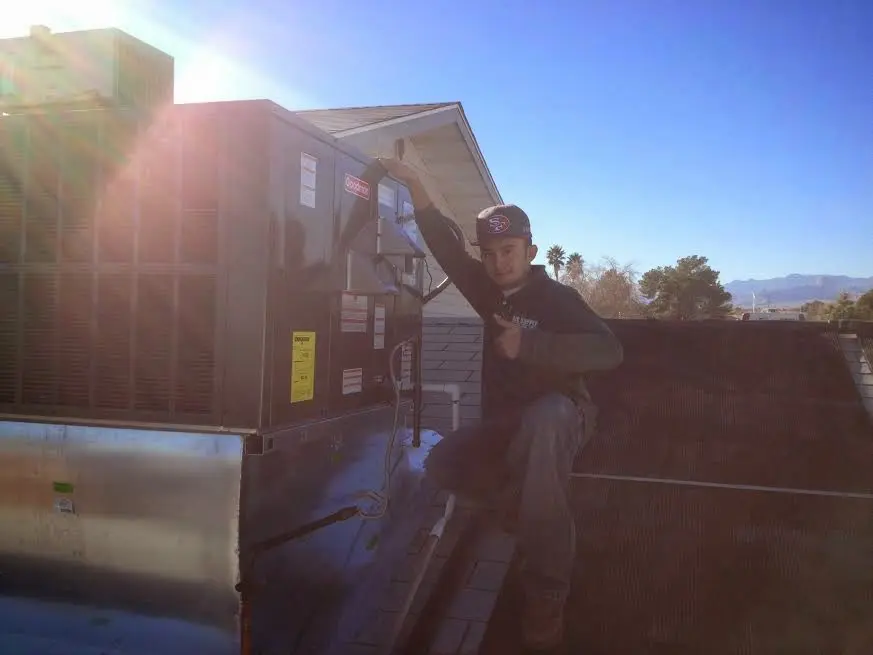 HVAC technician performing AC Tune-Up on a rooftop unit in Wilkes-Barre